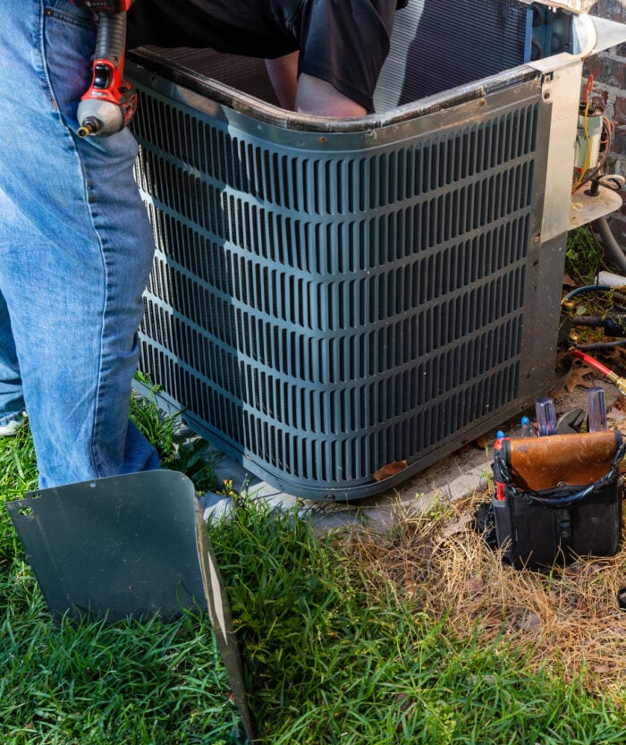 AC-repair HVAC professional servicing a heat pump system, ensuring optimal performance for residential comfort and efficiency.